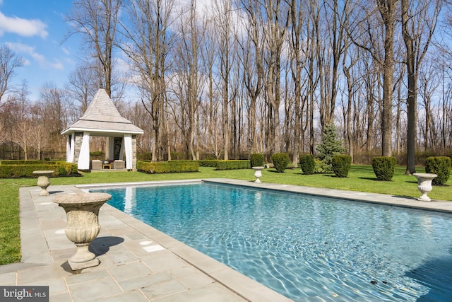 view of pool with a patio area, a gazebo, and a yard