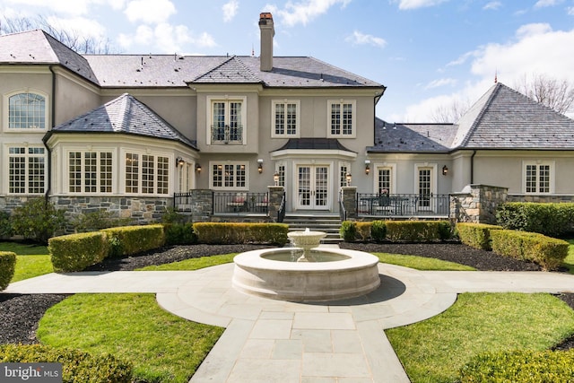 rear view of property featuring french doors