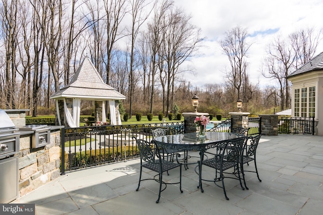 view of patio / terrace with a gazebo, exterior kitchen, and exterior bar