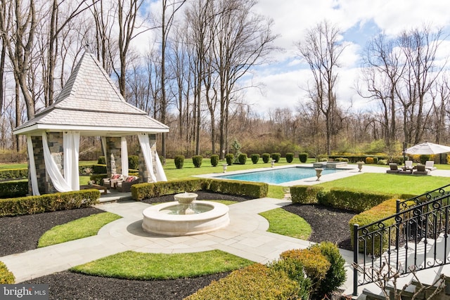 view of pool with a gazebo and a lawn