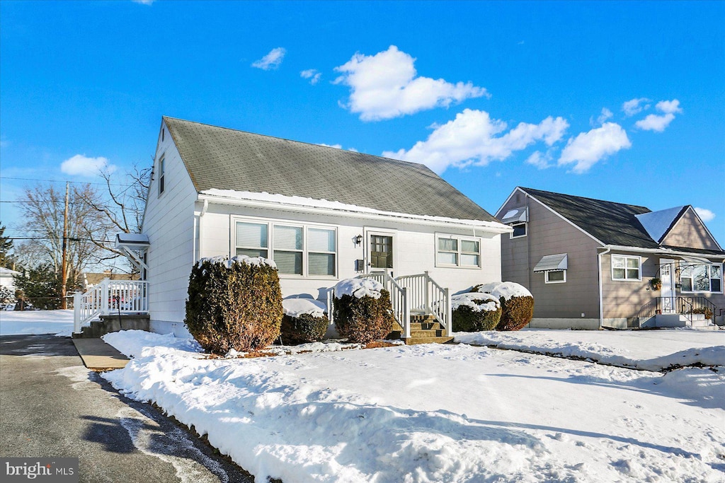 view of snow covered rear of property