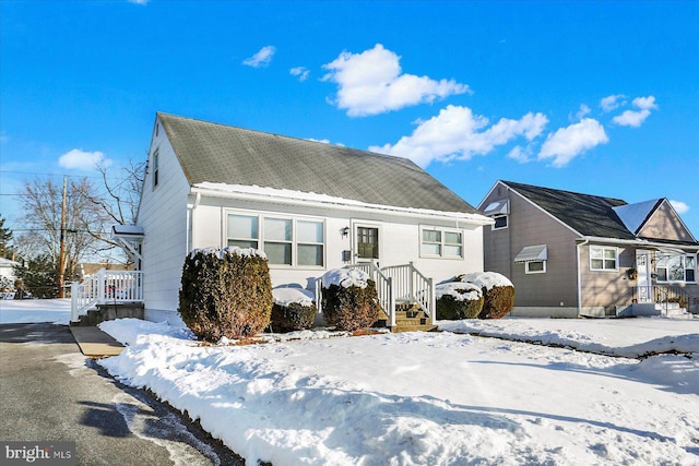 view of snow covered rear of property