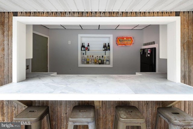 bar featuring black refrigerator