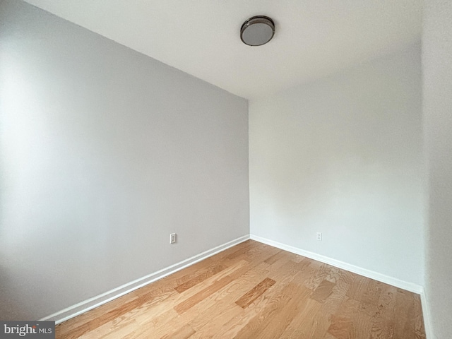 empty room with light hardwood / wood-style flooring