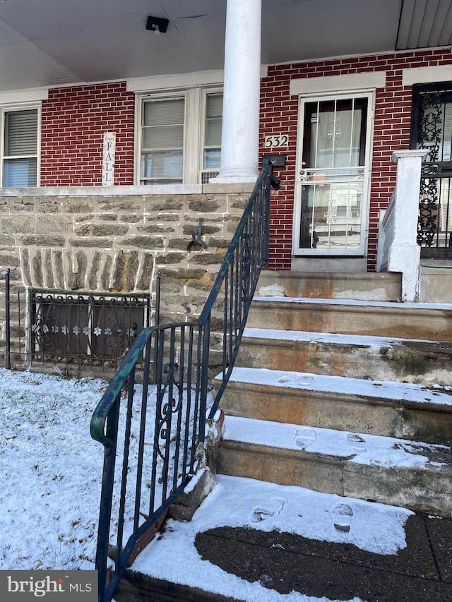 view of snow covered property entrance