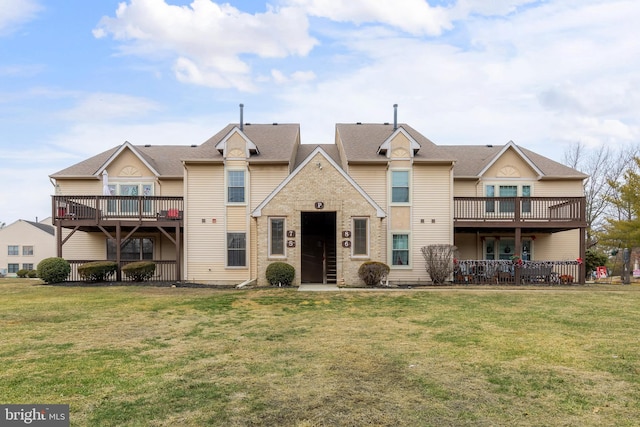 view of front of house with a front yard and a deck