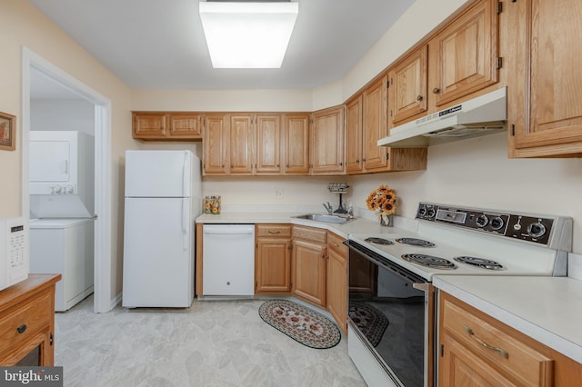 kitchen featuring sink, stacked washer and clothes dryer, and white appliances