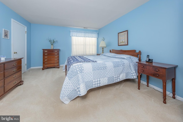 bedroom featuring light carpet