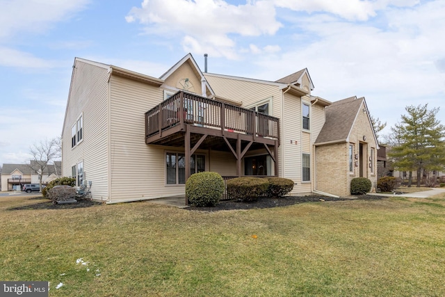 back of property with a wooden deck and a yard