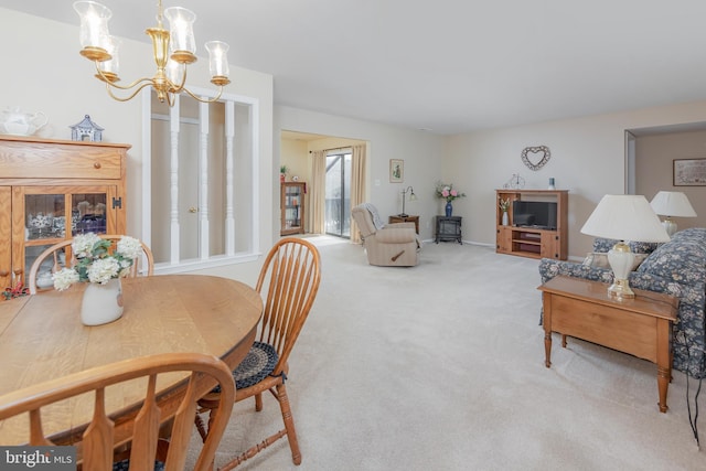 carpeted dining space featuring a notable chandelier