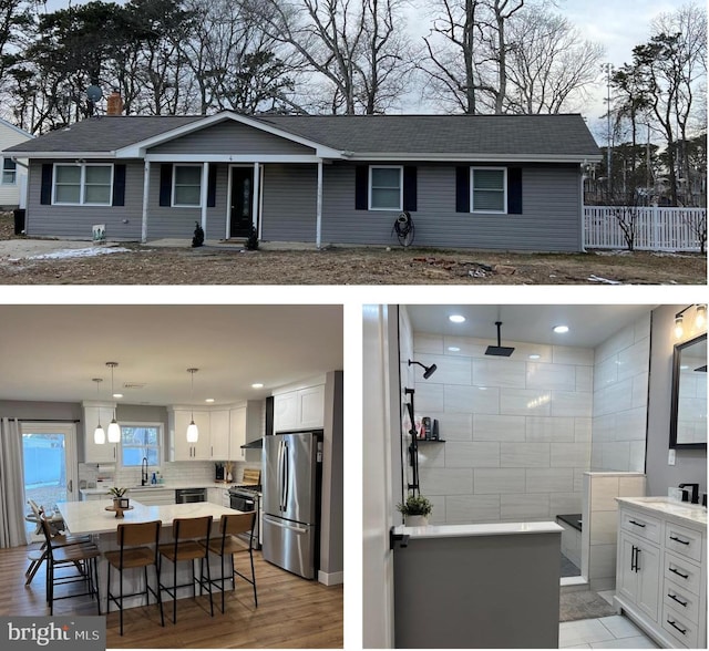 exterior space featuring a kitchen bar, white cabinets, appliances with stainless steel finishes, and a large island