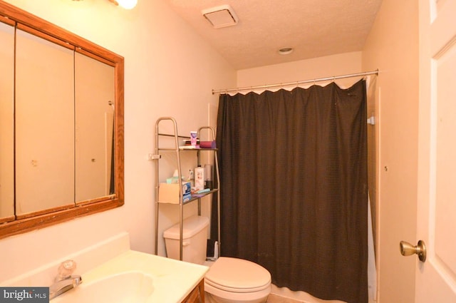 bathroom featuring a textured ceiling, toilet, vanity, and walk in shower