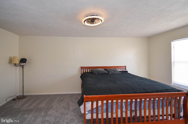 bedroom with a textured ceiling and carpet flooring