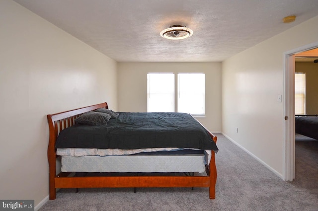 carpeted bedroom with a textured ceiling