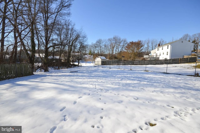 snowy yard with a shed