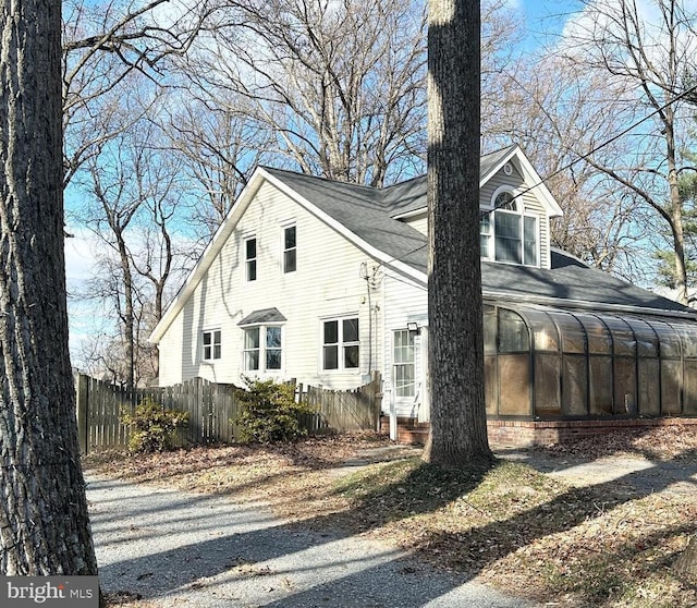 view of side of property featuring a sunroom