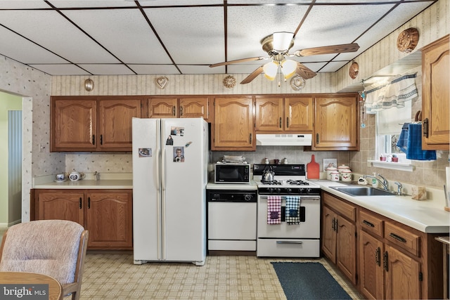 kitchen featuring ceiling fan, sink, and white appliances