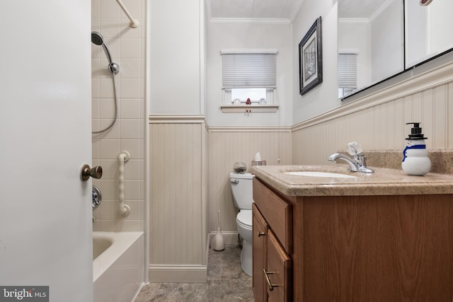 full bathroom with toilet, vanity, ornamental molding, and tiled shower / bath