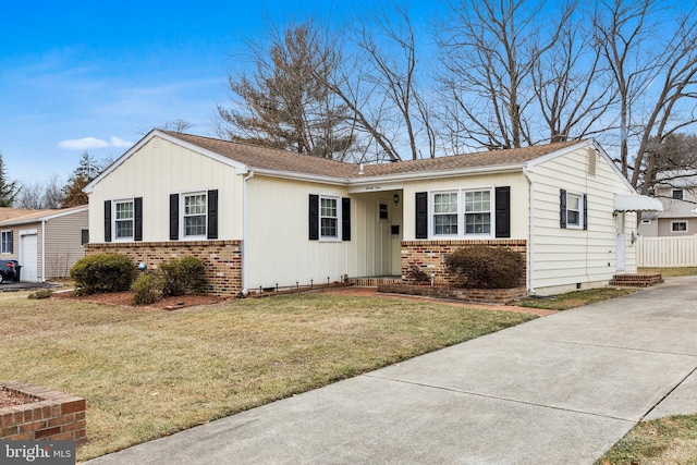 ranch-style home featuring a front lawn and a garage