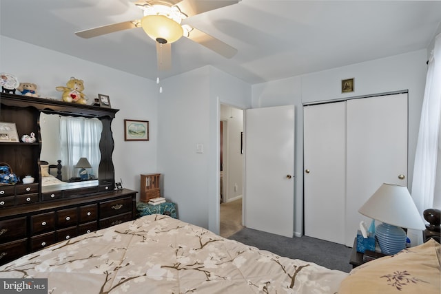 carpeted bedroom with ceiling fan and a closet