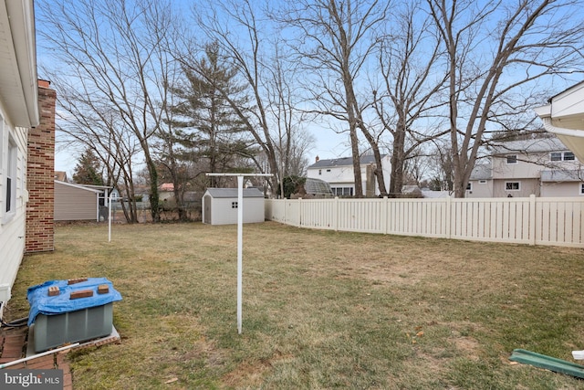 view of yard with central AC unit and a shed