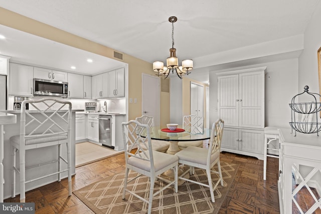 dining area featuring parquet floors and a notable chandelier