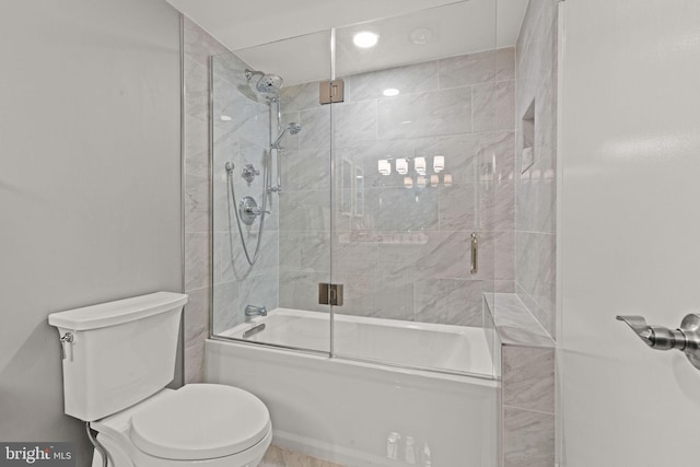 bathroom with shower / bath combination with glass door and toilet