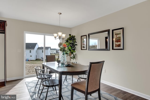 dining room featuring an inviting chandelier and hardwood / wood-style floors