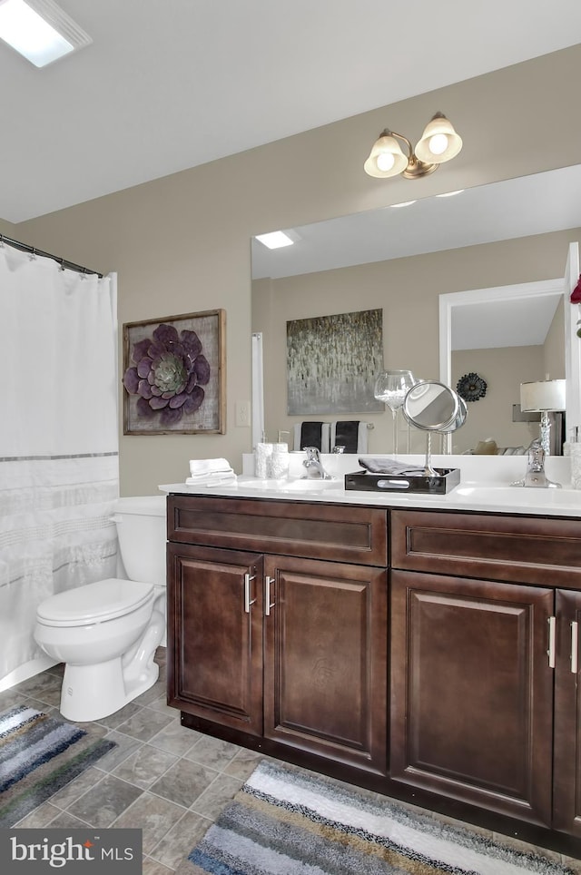 bathroom with toilet and vanity