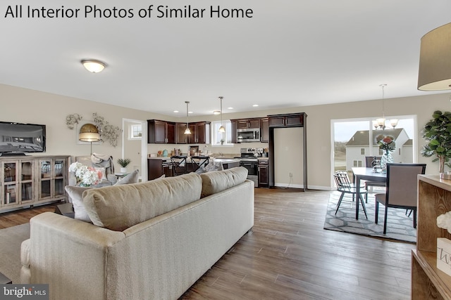 living room featuring hardwood / wood-style flooring and a notable chandelier