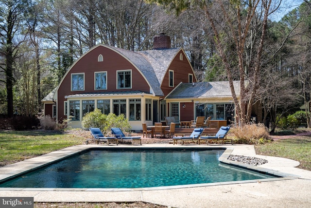 7705 Quaker Neck Rd, Bozman, MD 21612 - back of property featuring a patio, a chimney, an outdoor pool, and a lawn