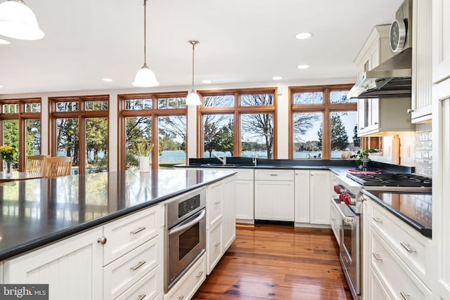 7705 Quaker Neck Rd, Bozman, MD 21612 - kitchen with appliances with stainless steel finishes, recessed lighting, dark wood-style flooring, white cabinets, and hanging light fixtures
