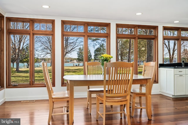 7705 Quaker Neck Rd, Bozman, MD 21612 - dining area with dark wood-style flooring, baseboards, recessed lighting, healthy amount of natural light, and crown molding