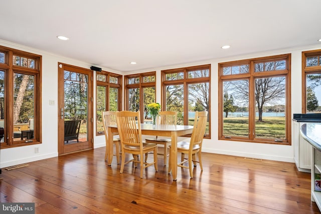 7705 Quaker Neck Rd, Bozman, MD 21612 - dining room featuring crown molding, a water view, baseboards, hardwood / wood-style floors, and recessed lighting
