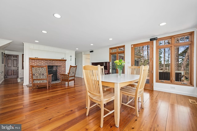 7705 Quaker Neck Rd, Bozman, MD 21612 - dining room featuring recessed lighting, light wood-style floors, a fireplace, baseboards, and crown molding