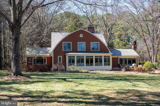 7705 Quaker Neck Rd, Bozman, MD 21612 - rear view of property featuring a chimney, a sunroom, a yard, and a deck