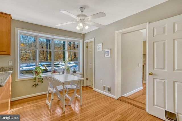 dining area featuring light wood-type flooring and ceiling fan