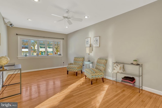 sitting room featuring ceiling fan and light hardwood / wood-style flooring