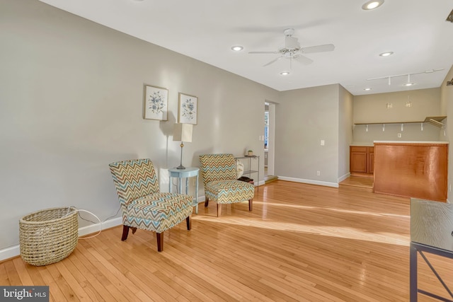 sitting room with ceiling fan and light hardwood / wood-style floors