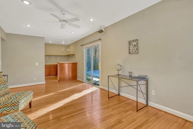 sitting room with ceiling fan and light hardwood / wood-style floors