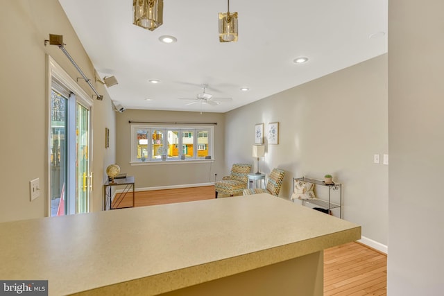 kitchen featuring ceiling fan and light hardwood / wood-style flooring