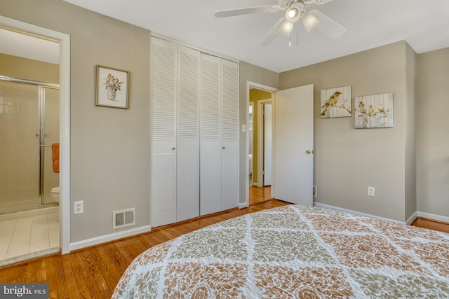 bedroom with ceiling fan, ensuite bath, a closet, and hardwood / wood-style floors