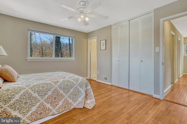 bedroom featuring ceiling fan, a closet, and light hardwood / wood-style floors