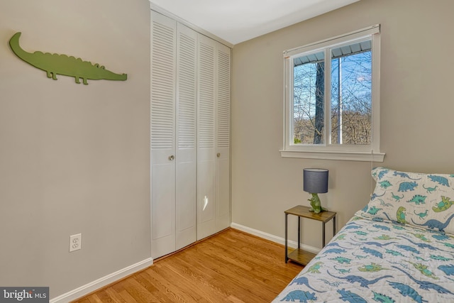 bedroom with a closet and hardwood / wood-style flooring