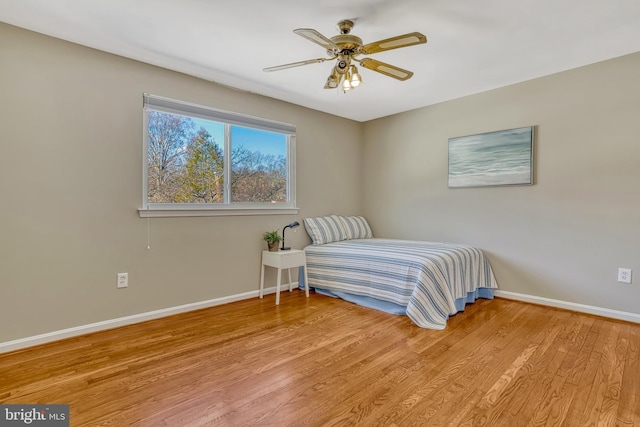 bedroom with ceiling fan and light hardwood / wood-style floors