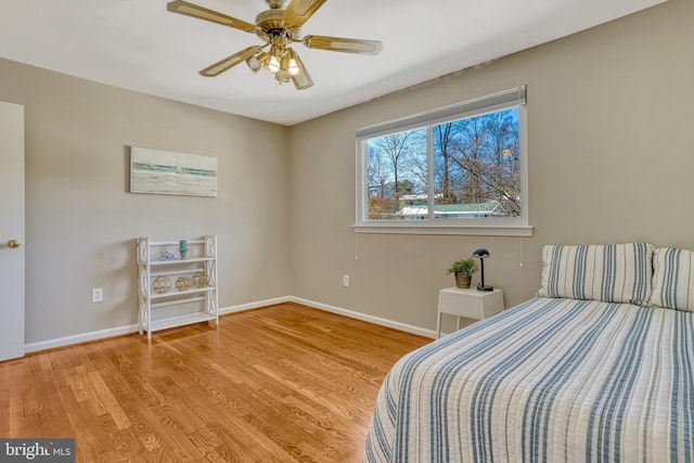 bedroom with ceiling fan and light hardwood / wood-style floors