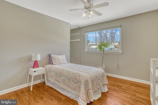 bedroom with ceiling fan and wood-type flooring