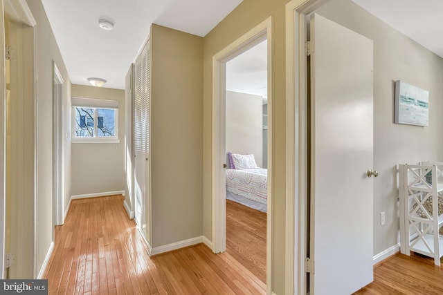 corridor with light hardwood / wood-style floors