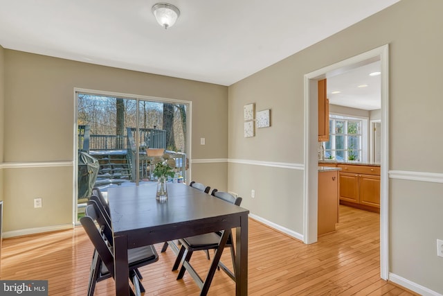 dining space with light hardwood / wood-style floors