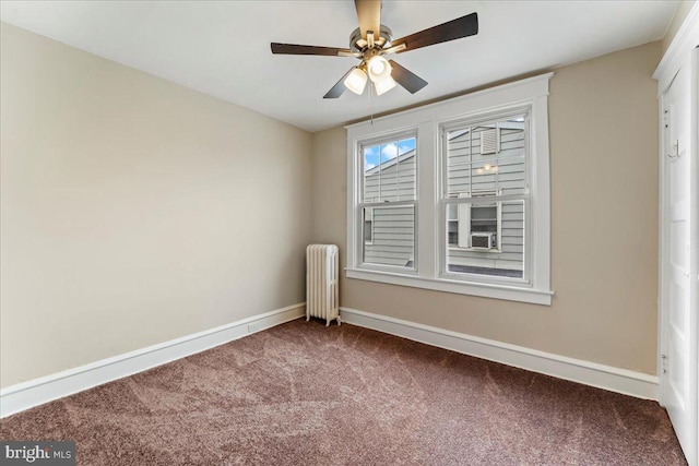 spare room with ceiling fan, carpet, and radiator heating unit